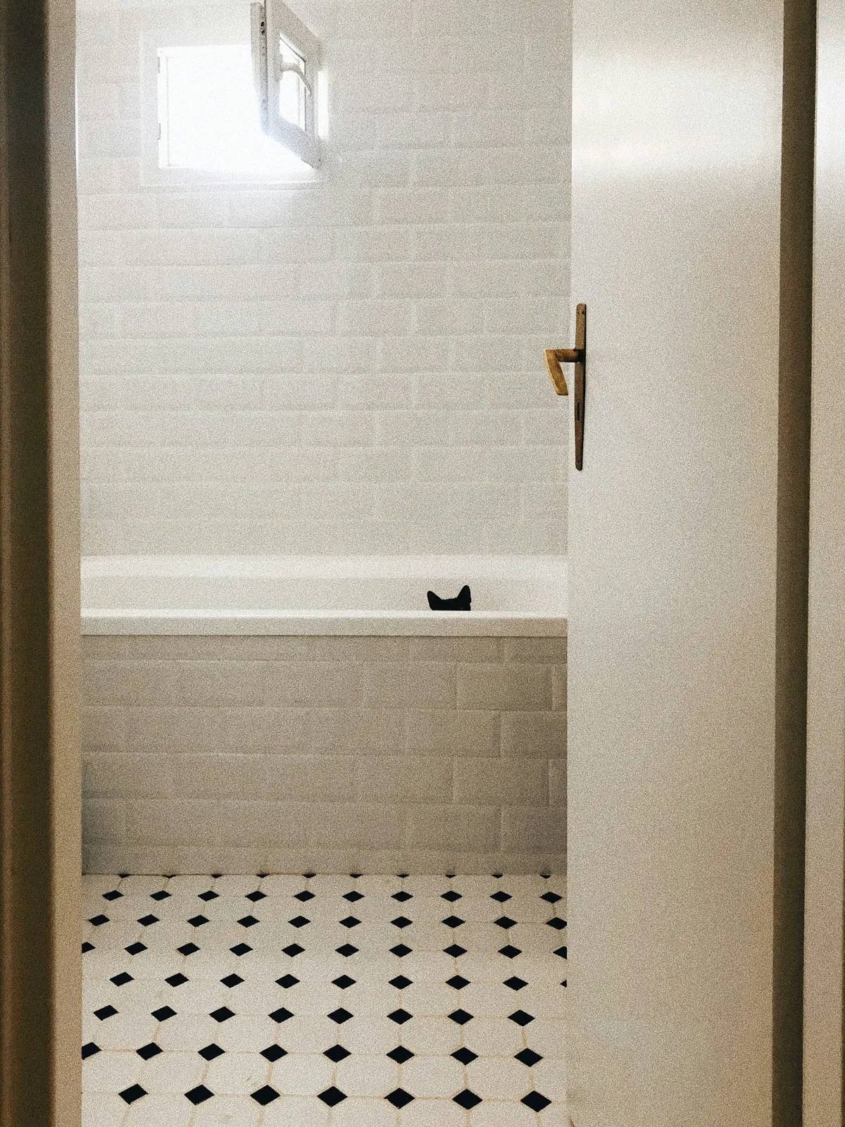 Subway tile walls over a black and white octagon floor