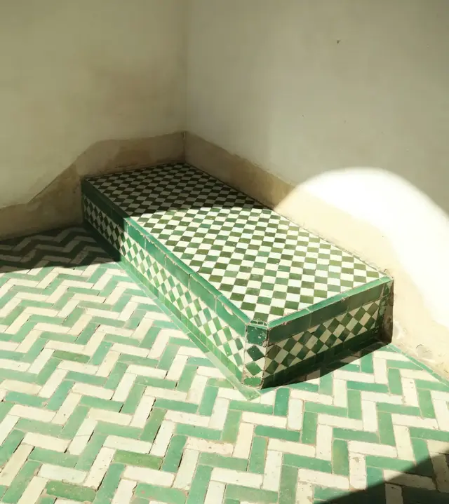 Green and white zellige tile on a bench